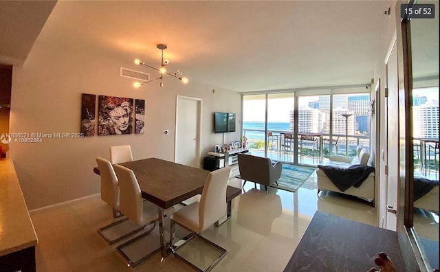 495 Brickell Ave Unit 1205, Miami, FL 33131 - dining space featuring a chandelier and floor to ceiling windows