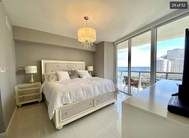 495 Brickell Ave Unit 1205, Miami, FL 33131 - bedroom featuring access to outside, a chandelier, light tile patterned flooring, expansive windows, and a city view