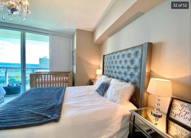 495 Brickell Ave Unit 1205, Miami, FL 33131 - bedroom featuring multiple windows and a chandelier
