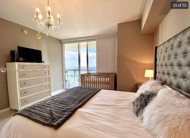 495 Brickell Ave Unit 1205, Miami, FL 33131 - bedroom with access to outside, a chandelier, and a wall of windows
