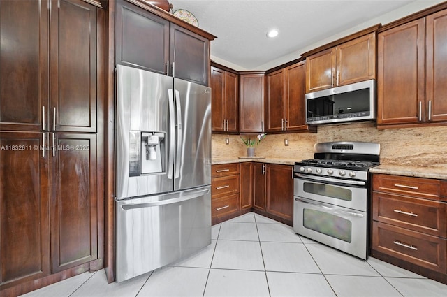 5194 NW 106th Ave, Doral, FL 33178 - kitchen with stainless steel appliances, light tile patterned floors, light stone counters, decorative backsplash, and recessed lighting
