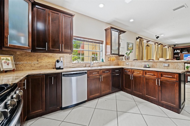 5194 NW 106th Ave, Doral, FL 33178 - kitchen featuring appliances with stainless steel finishes, a peninsula, light tile patterned floors, backsplash, and light stone countertops