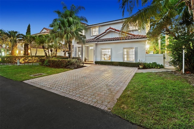 5194 NW 106th Ave, Doral, FL 33178 - mediterranean / spanish-style house featuring decorative driveway, stucco siding, and a tiled roof