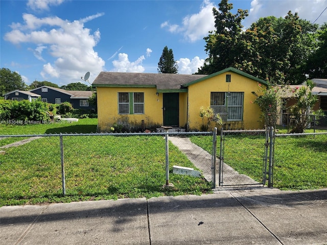 2365 NW 79th Ter, Miami, FL 33147 - single story home featuring stucco siding, a gate, and a fenced front yard