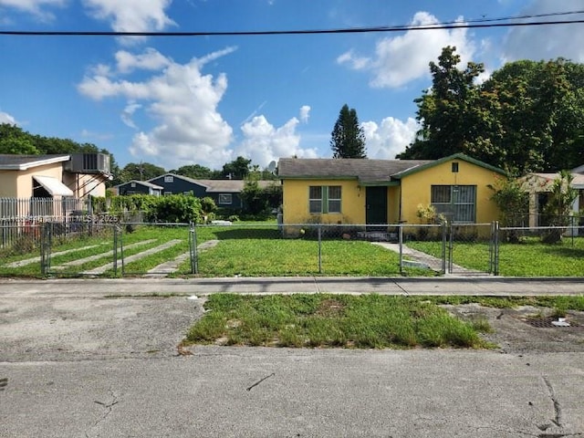 2365 NW 79th Ter, Miami, FL 33147 - ranch-style home with stucco siding and a fenced front yard