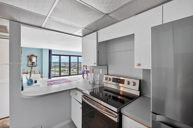 11111 Biscayne Blvd Unit 2100, Miami, FL 33181 - kitchen featuring appliances with stainless steel finishes, white cabinets, and a paneled ceiling