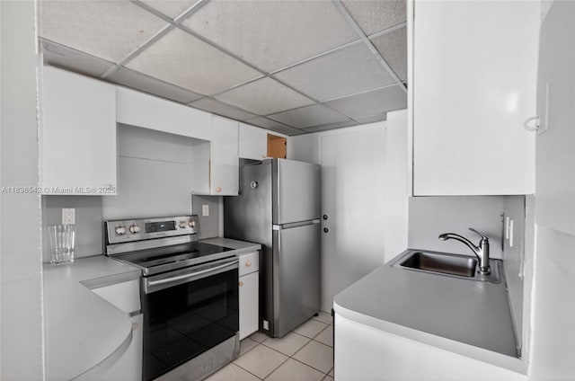 11111 Biscayne Blvd Unit 2100, Miami, FL 33181 - kitchen featuring appliances with stainless steel finishes, white cabinetry, a drop ceiling, light tile patterned flooring, and light countertops