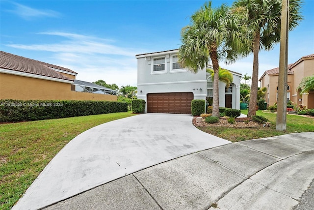 15376 NW 14th Mnr, Pembroke Pines, FL 33028 - view of front of house featuring an attached garage, a front lawn, concrete driveway, and stucco siding