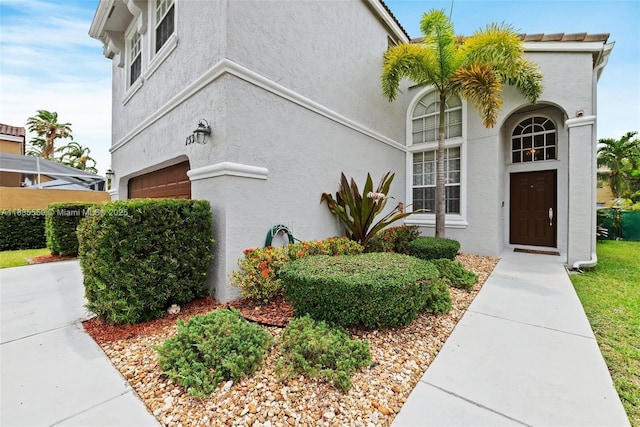 15376 NW 14th Mnr, Pembroke Pines, FL 33028 - view of side of property with stucco siding and a garage