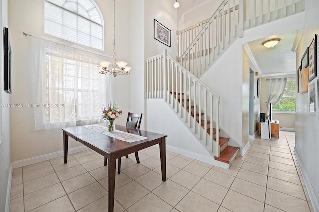 15376 NW 14th Mnr, Pembroke Pines, FL 33028 - dining room with stairs, a chandelier, light tile patterned floors, ornamental molding, and a high ceiling