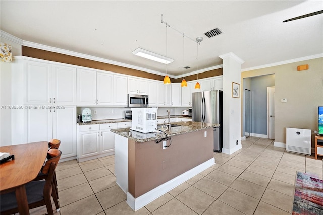 15376 NW 14th Mnr, Pembroke Pines, FL 33028 - kitchen featuring appliances with stainless steel finishes, ornamental molding, light tile patterned floors, light stone countertops, and white cabinetry