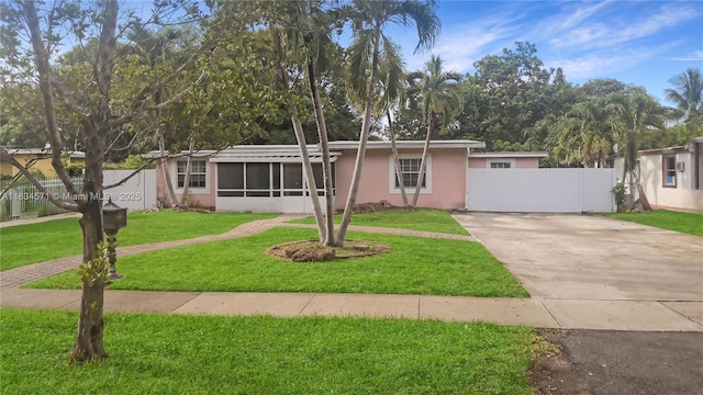 841 NE 139th St, North Miami, FL 33161 - view of front of home with driveway, stucco siding, and a sunroom