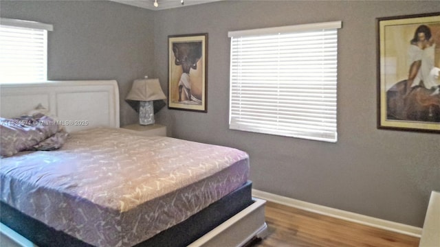 841 NE 139th St, North Miami, FL 33161 - bedroom featuring wood finished floors and multiple windows