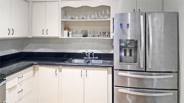 841 NE 139th St, North Miami, FL 33161 - kitchen with stainless steel fridge with ice dispenser, dark countertops, and white cabinetry