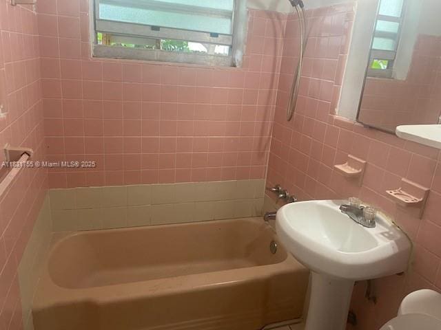 1990 NE 168th St, North Miami Beach, FL 33162 - bathroom featuring shower / bathtub combination and tile walls