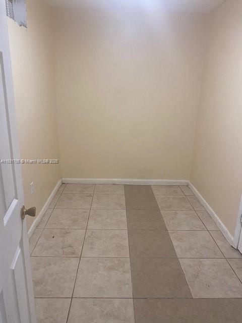 1990 NE 168th St, North Miami Beach, FL 33162 - unfurnished room with light tile patterned floors and baseboards