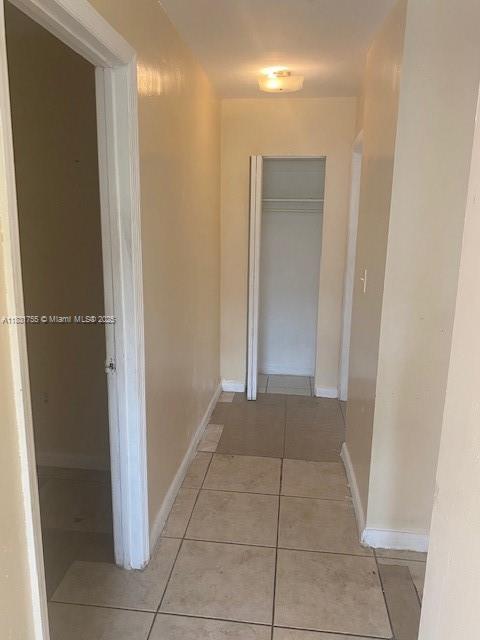 1990 NE 168th St, North Miami Beach, FL 33162 - corridor featuring light tile patterned floors and baseboards