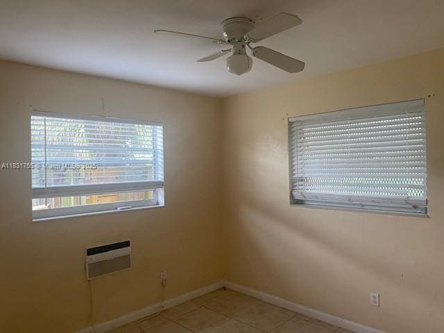 1990 NE 168th St, North Miami Beach, FL 33162 - spare room featuring ceiling fan, light tile patterned floors, and a wall unit AC