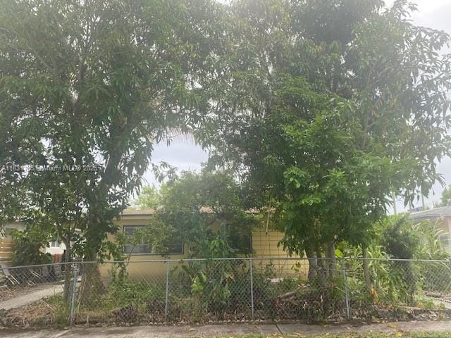 1990 NE 168th St, North Miami Beach, FL 33162 - view of home's exterior with a fenced front yard