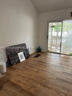 10441 Mahogany Key Cir Unit 202, Miami, FL 33196 - unfurnished living room with vaulted ceiling and wood finished floors