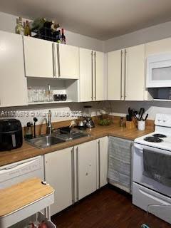 10441 Mahogany Key Cir Unit 202, Miami, FL 33196 - kitchen with white appliances, white cabinetry, and dark wood finished floors