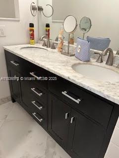 10441 Mahogany Key Cir Unit 202, Miami, FL 33196 - bathroom featuring marble look tile flooring and double vanity