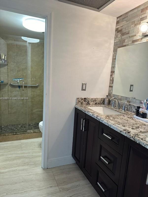 500 Bayview Dr Unit Ph-18, Sunny Isles Beach, FL 33160 - full bath featuring double vanity, a shower stall, and wood finished floors
