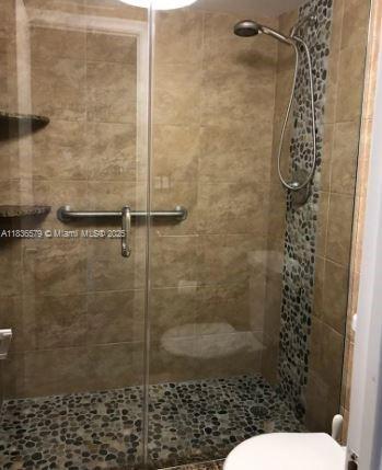 500 Bayview Dr Unit Ph-18, Sunny Isles Beach, FL 33160 - bathroom featuring toilet and a shower stall