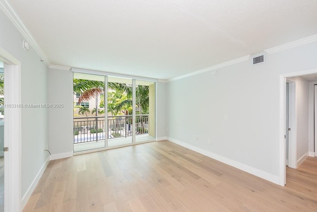2000 N Bayshore Dr Unit 203, Miami, FL 33137 - unfurnished room with healthy amount of natural light, light wood-type flooring, crown molding, and a wall of windows