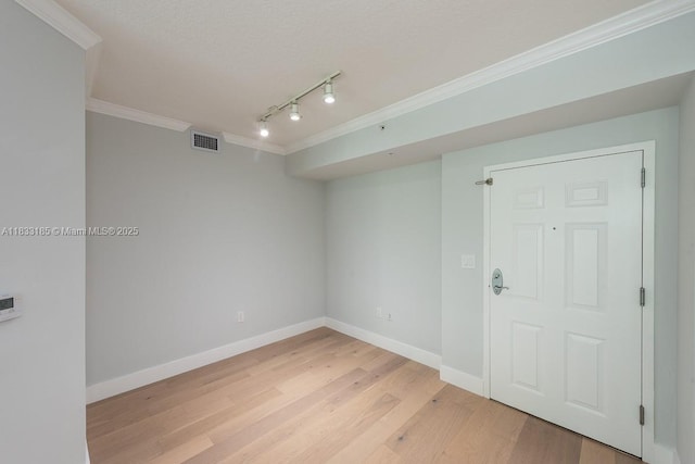 2000 N Bayshore Dr Unit 203, Miami, FL 33137 - empty room featuring ornamental molding, rail lighting, and light wood-style floors