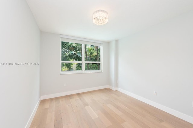 2000 N Bayshore Dr Unit 203, Miami, FL 33137 - spare room featuring light wood-style floors and a chandelier