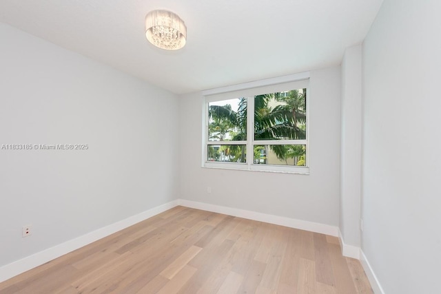 2000 N Bayshore Dr Unit 203, Miami, FL 33137 - empty room with light wood-style flooring and a chandelier