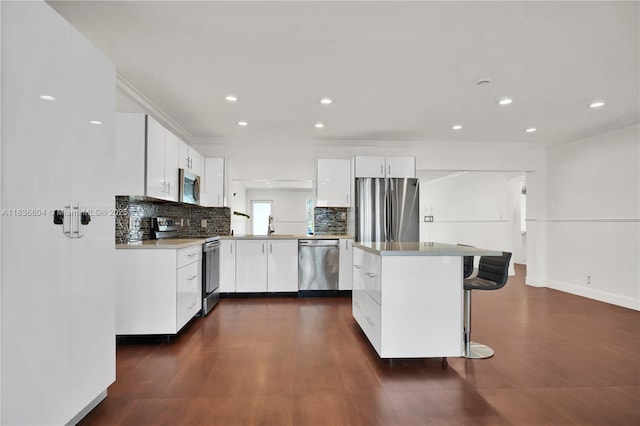 4721 W Park Rd, Hollywood, FL 33021 - kitchen with stainless steel appliances, backsplash, dark wood-style floors, white cabinets, and ornamental molding