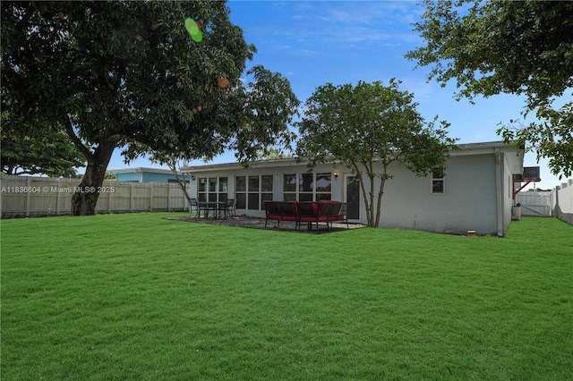 4721 W Park Rd, Hollywood, FL 33021 - rear view of property featuring a fenced backyard, stucco siding, a patio area, and a sunroom