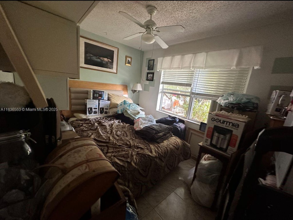 2120 SW 42nd Ter, Fort Lauderdale, FL 33317 - tiled bedroom featuring a textured ceiling and ceiling fan