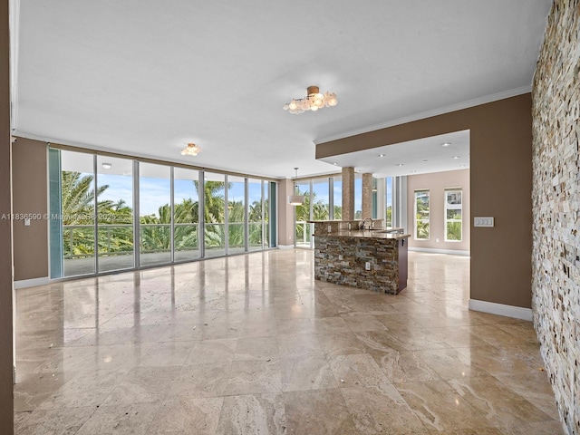 2645 S Bayshore Dr Unit 304, Miami, FL 33133 - unfurnished living room featuring a chandelier, ornamental molding, and floor to ceiling windows