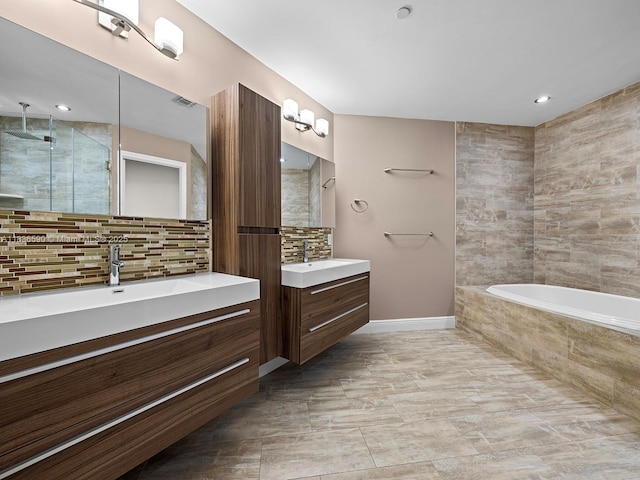 2645 S Bayshore Dr Unit 304, Miami, FL 33133 - bathroom featuring decorative backsplash, two vanities, a garden tub, a walk in shower, and recessed lighting