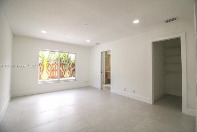 10204 Caracas St, Cooper City, FL 33026 - unfurnished bedroom with a walk in closet, recessed lighting, and ensuite bath