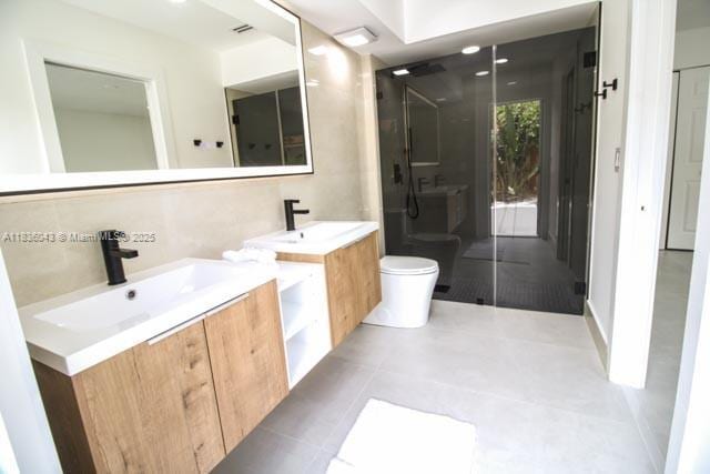 10204 Caracas St, Cooper City, FL 33026 - bathroom featuring two vanities and a stall shower