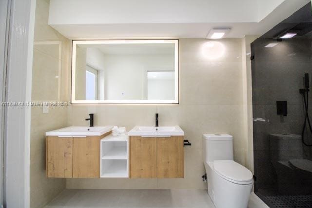 10204 Caracas St, Cooper City, FL 33026 - bathroom featuring double vanity, a shower stall, and tile walls