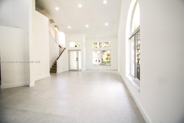 10204 Caracas St, Cooper City, FL 33026 - unfurnished living room featuring stairway, recessed lighting, and a towering ceiling