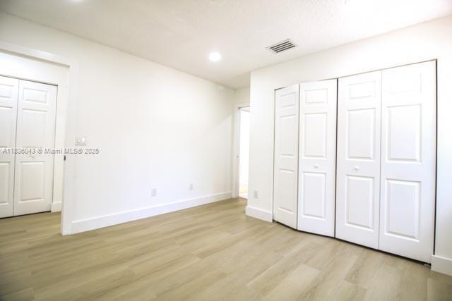 10204 Caracas St, Cooper City, FL 33026 - unfurnished bedroom with light wood-style flooring and recessed lighting