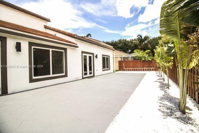 10204 Caracas St, Cooper City, FL 33026 - fenced backyard with french doors and a patio area