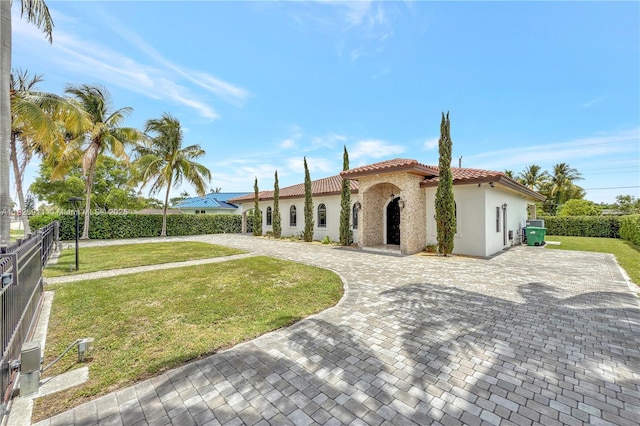 7970 SW 26th St, Miami, FL 33155 - mediterranean / spanish-style home with a tile roof, stucco siding, curved driveway, and a patio area