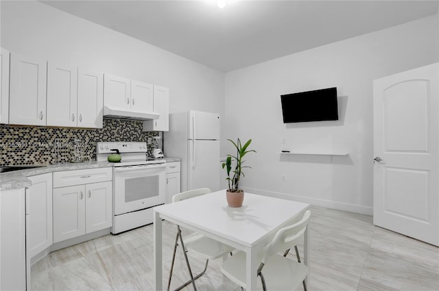 7970 SW 26th St, Miami, FL 33155 - kitchen with white appliances, under cabinet range hood, backsplash, and white cabinetry