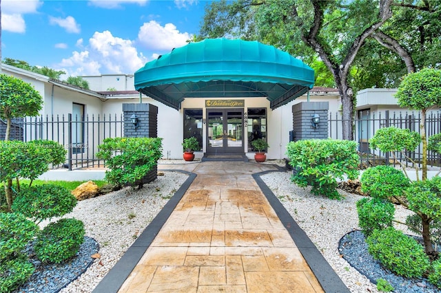 6886 N Kendall Dr Unit D102, Pinecrest, FL 33156 - view of exterior entry featuring french doors and stucco siding