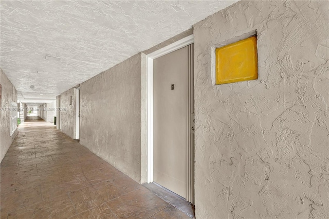 6886 N Kendall Dr Unit D102, Pinecrest, FL 33156 - hallway featuring a textured wall