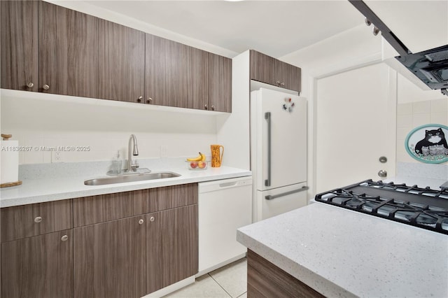 6886 N Kendall Dr Unit D102, Pinecrest, FL 33156 - kitchen featuring white appliances, light countertops, dark brown cabinets, and light tile patterned flooring