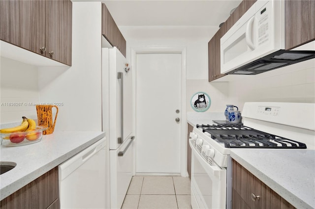 6886 N Kendall Dr Unit D102, Pinecrest, FL 33156 - kitchen with white appliances, light tile patterned floors, modern cabinets, decorative backsplash, and light stone countertops