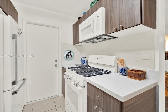6886 N Kendall Dr Unit D102, Pinecrest, FL 33156 - kitchen with white appliances, light tile patterned floors, backsplash, and modern cabinets